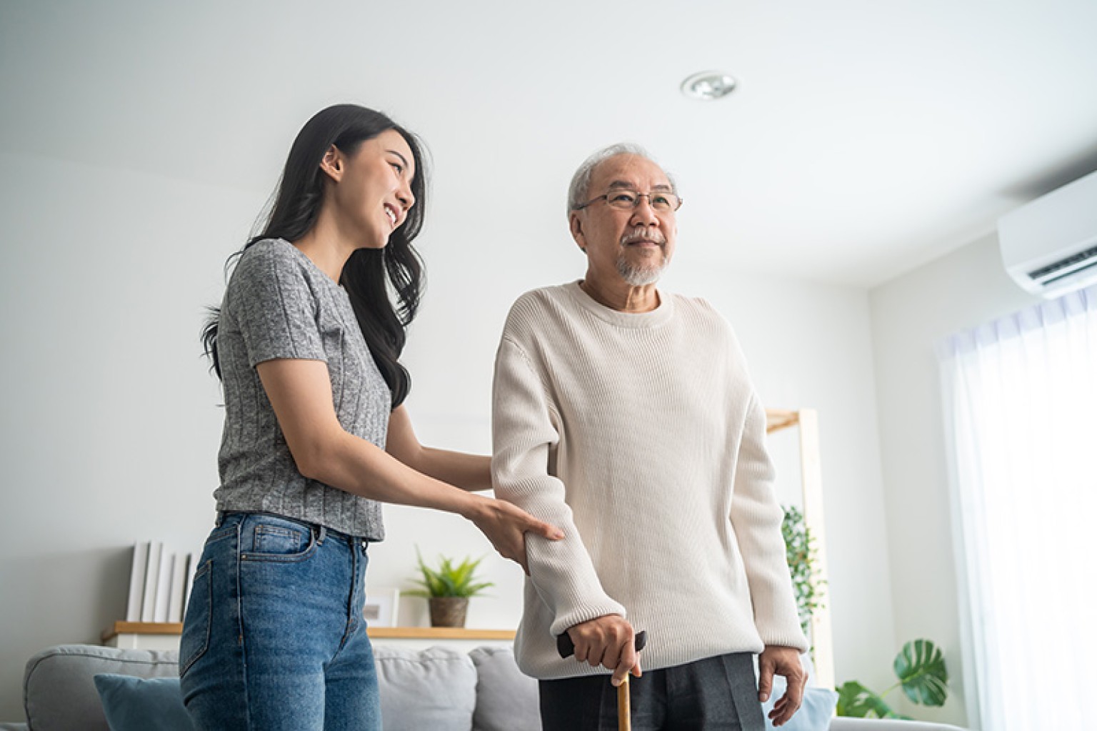 grand daughter helping a man in his home