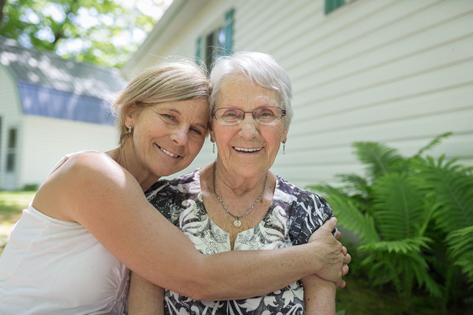 mother and daughter embracing and smiling