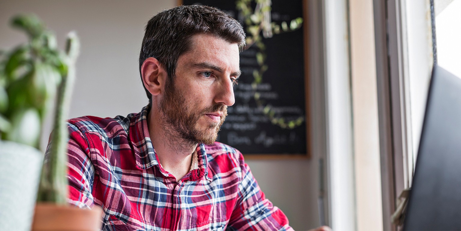 man sitting at computer