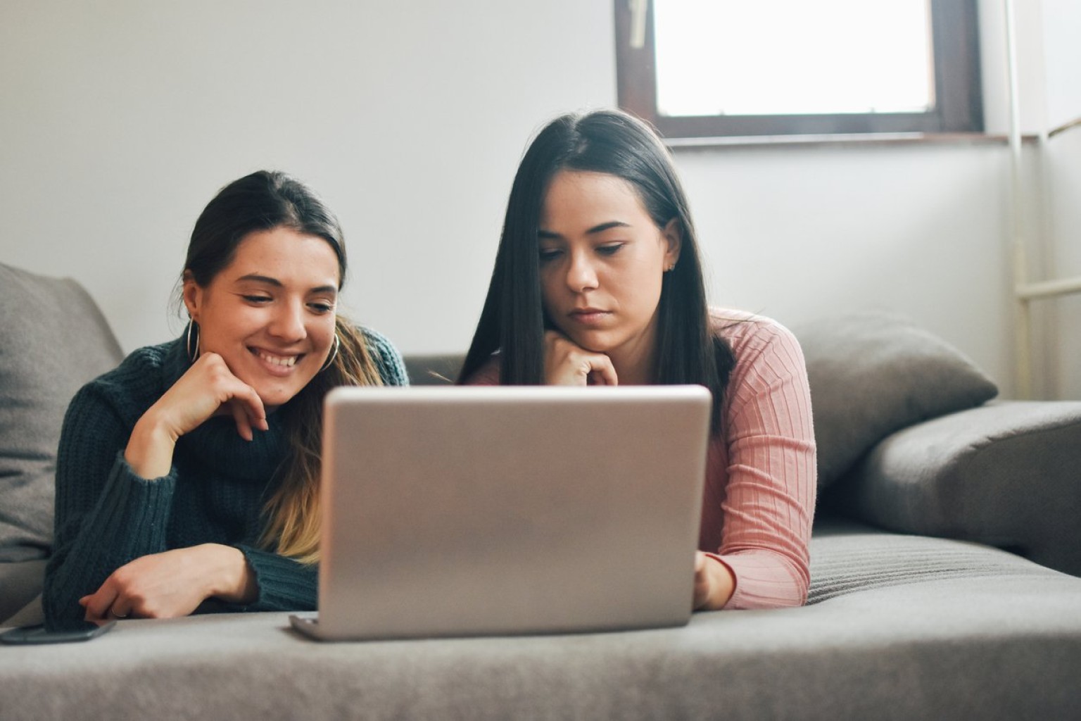 photo of two girls with a laptop