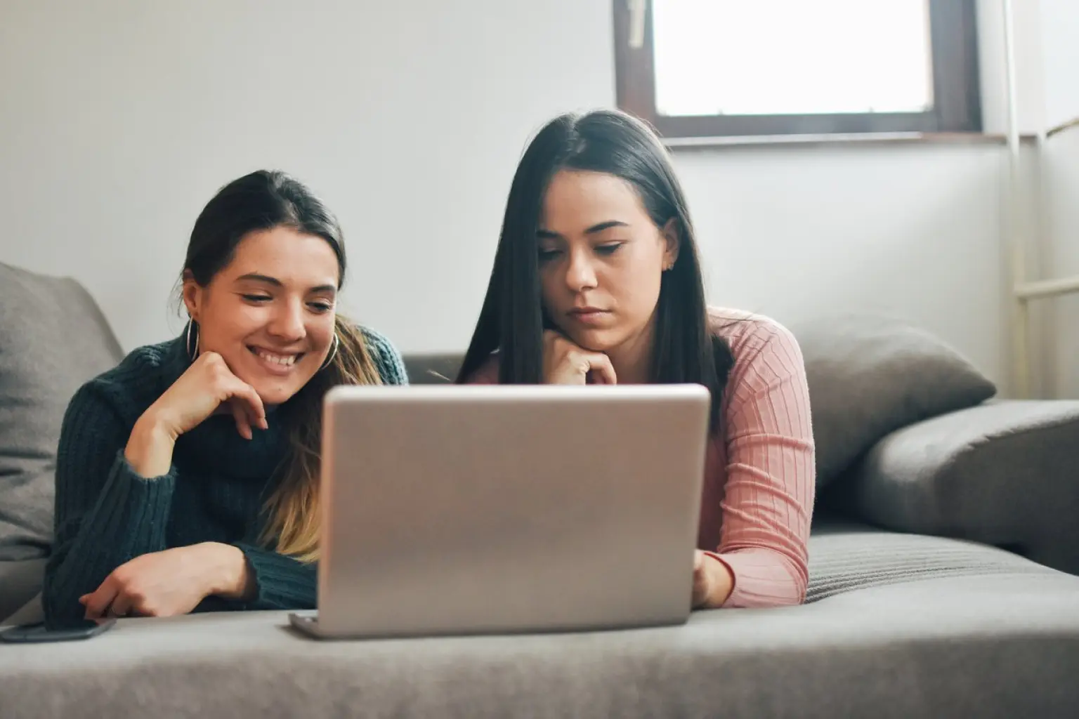 photo of two girls with a laptop